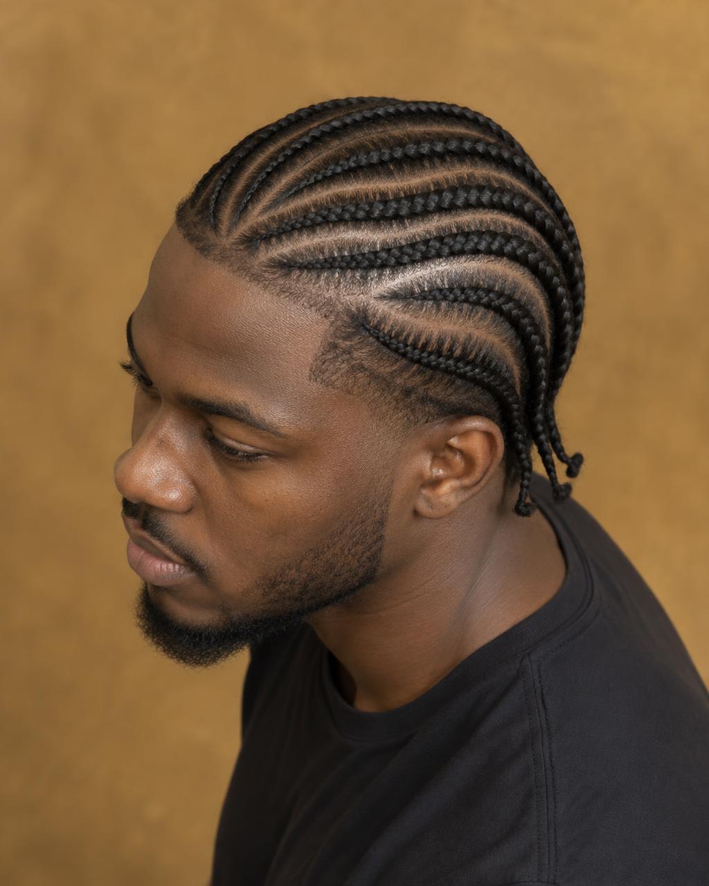 Man wearing precise curved cornrows with short braided ends